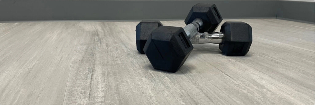 Dumbbells on faux wood rubber flooring