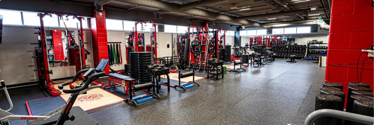 Gym with rubber flooring and row of weight machines