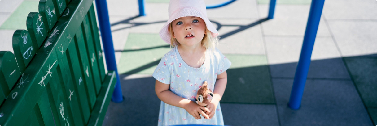 Young child holding stuffed animal